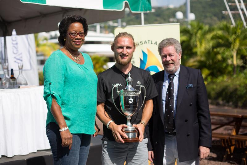 From the inaugural 2014 race: L to R: The Minister for Tourism & Civil Aviation, the Honourable Yolande Bain-Horsford, Fred Pilkington and Andrew McIrvine, RORC Admiral and IMA Secretary General presents the 2014 line honours and overall winner, Jeremy Pilkington's Baltic 78, Lupa of London with the IMA line honours trophy. Lupa's elapsed time of 11 days, 01 hour, 38 minutes and 55 seconds set the record for others to beat this year © RORC/Arthur Daniel & Orlando K Romain